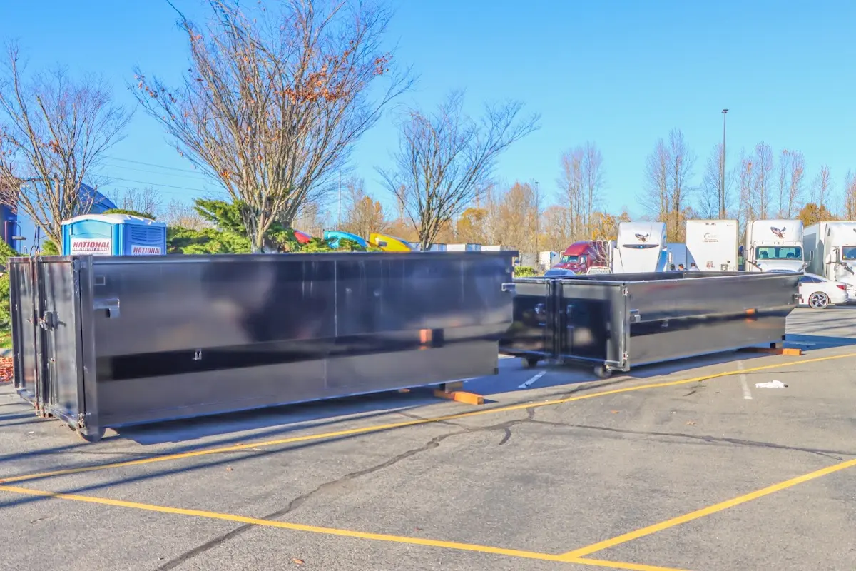 Professional dumpster rental service with roll-off container on residential driveway in Gulf Shores